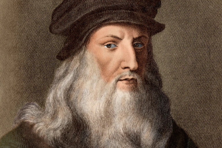 A coloured print of Da Vinci shows him with a long white beard and brown hat.