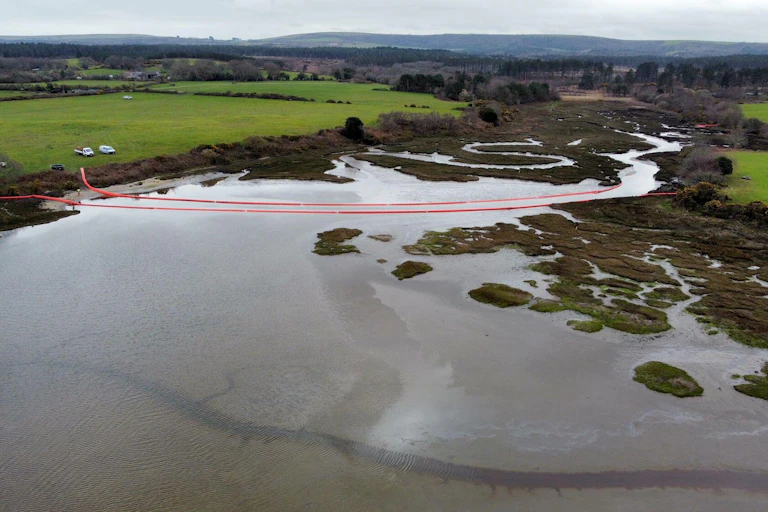 Aerial view of a river crossed by red floats