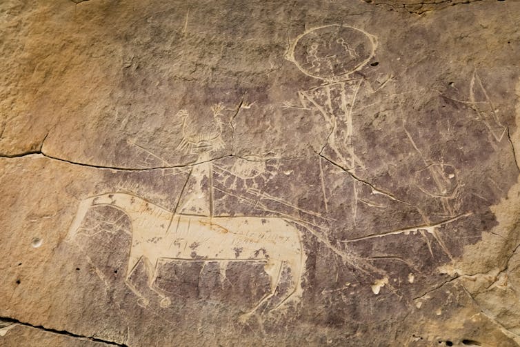 Rock art silhouette of horse and rider