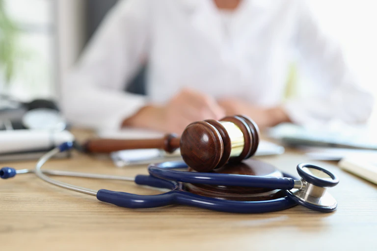 Closeup of judge gavel of stethoscope doctor