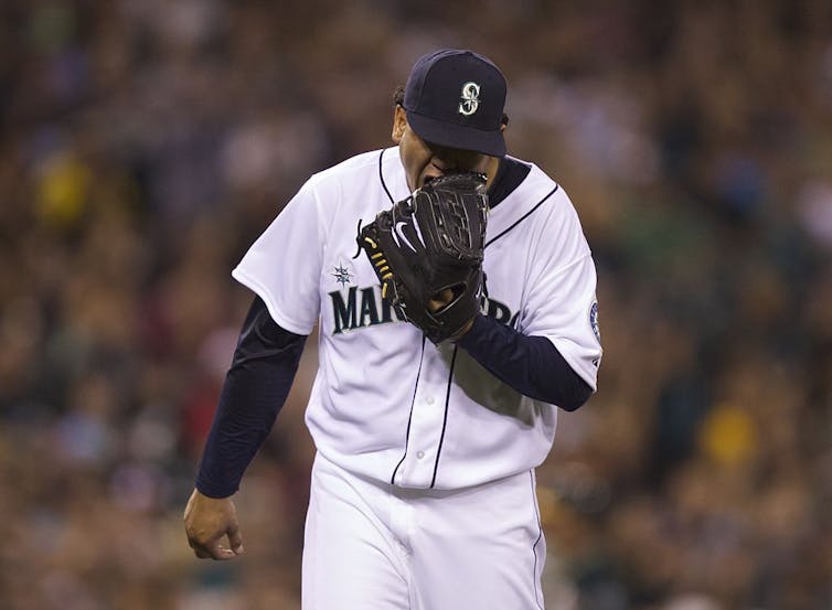 Pitcher screams into glove.