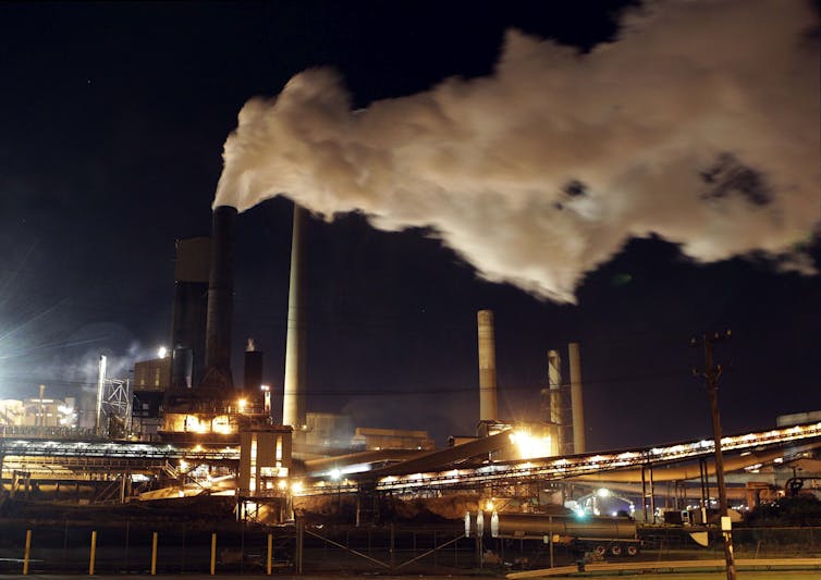 steam billowing from industrial facility