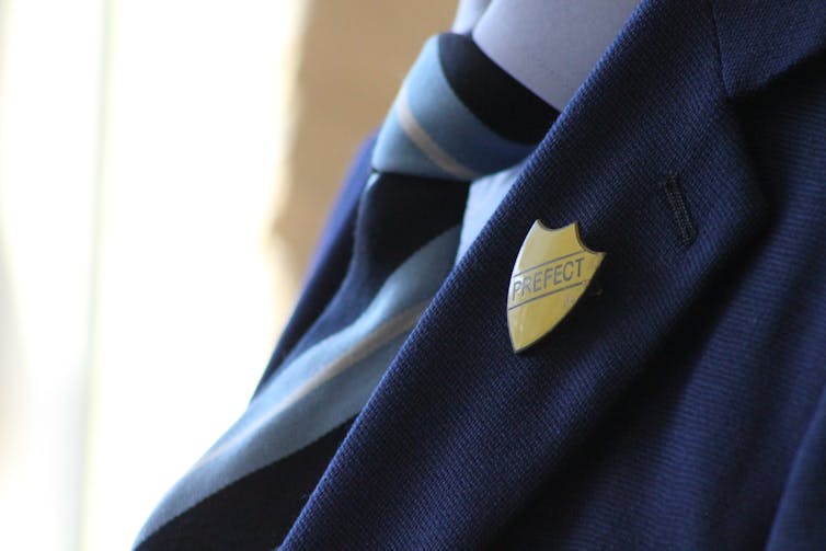 Close-up of a uniform jacket, shirt and tie.