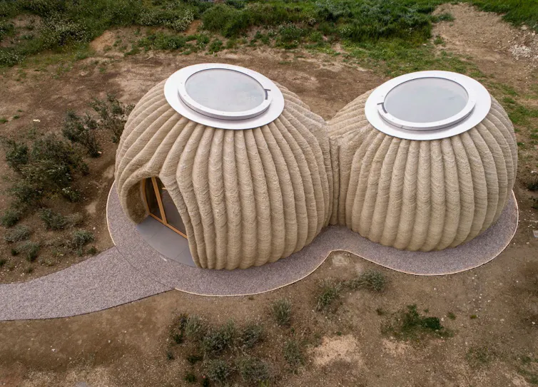 Aerial view of two rounded dwellings made from clay.