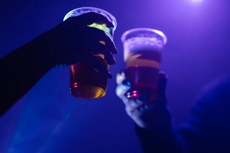 People toasting plastic cups of beer