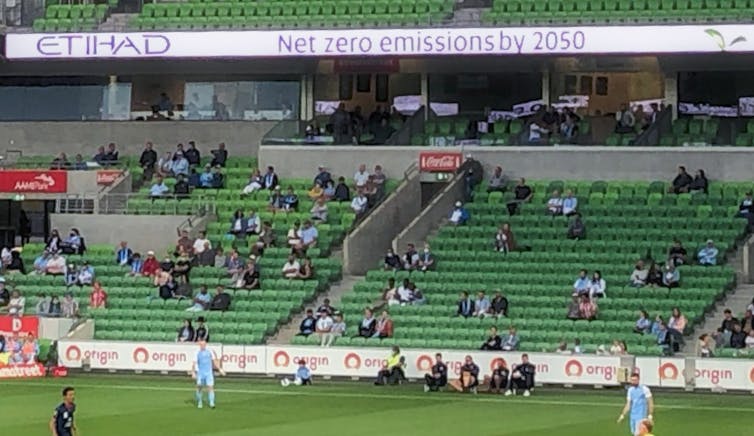 An Etihad Airways advertisement stating 'Net zero emissions by 2050' is displayed above the stands at an A-League soccer match at AAMI Park in Melbourne on Tuesday, February 15, 2022