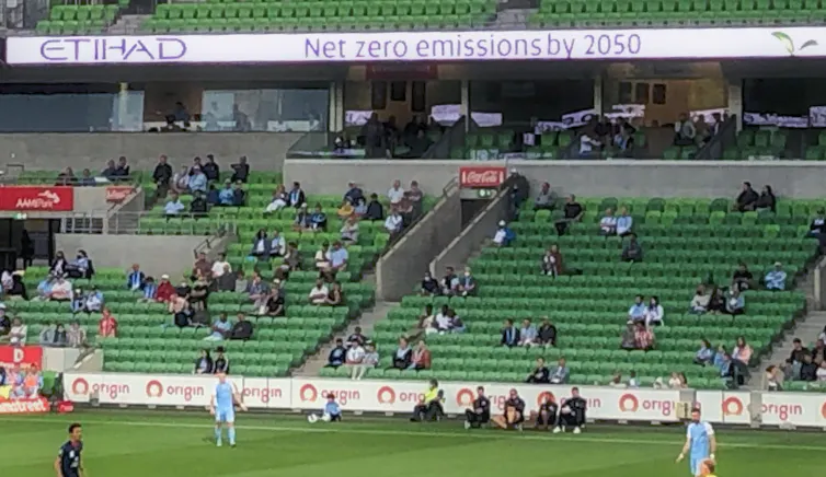 An Etihad Airways advertisement stating 'Net zero emissions by 2050' is displayed above the stands at an A-League soccer match at AAMI Park in Melbourne on Tuesday, February 15, 2022