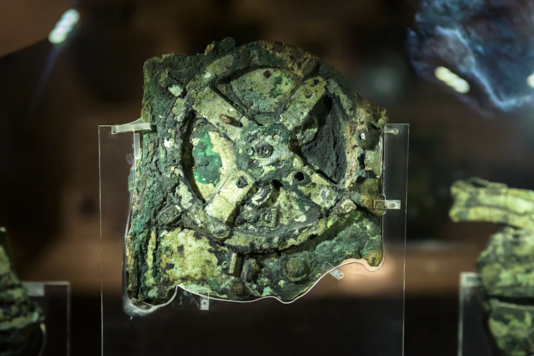 A stone looking roughly like a cog in various shades of green