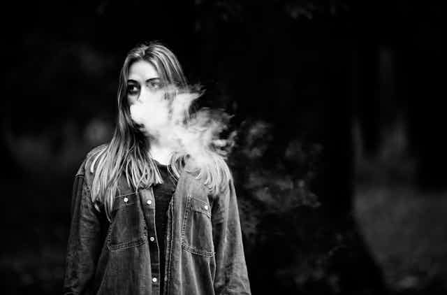 A young woman vaping. 