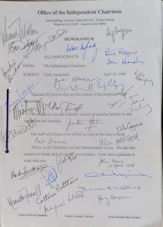 The front page of the Good Friday Agreement covered in lots of different signatures.