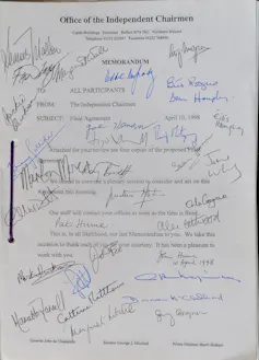 The front page of the Good Friday Agreement covered in lots of different signatures.