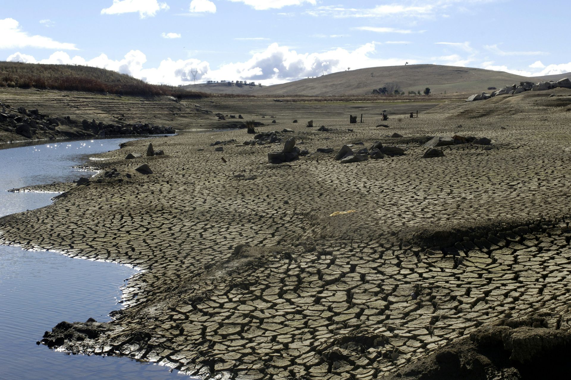 dry, cracked earth and dam
