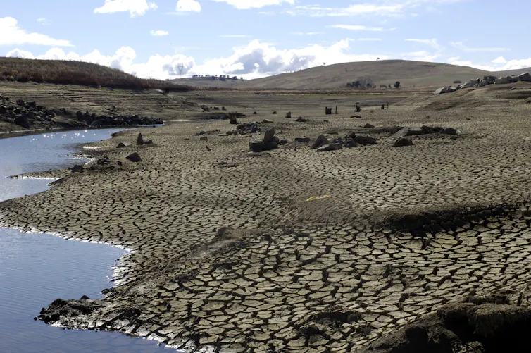 dry, cracked earth and dam