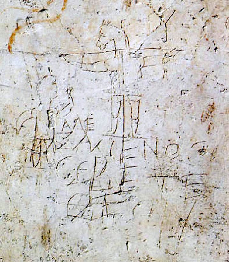 Crude scratchings: a young man worshipping a crucified, donkey-headed figure.