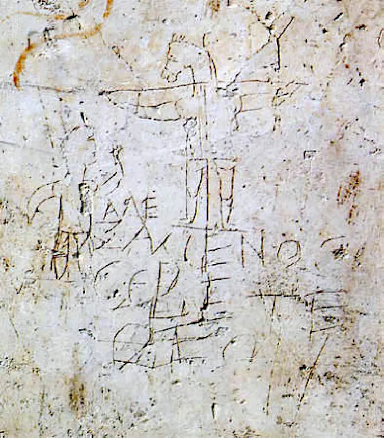 Crude scratchings: a young man worshipping a crucified, donkey-headed figure.