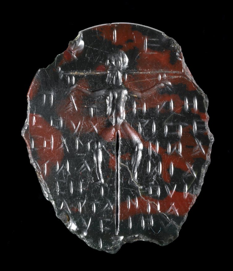Green-brown jasper; oval with a crucified figure on a tall cross with a short base.
