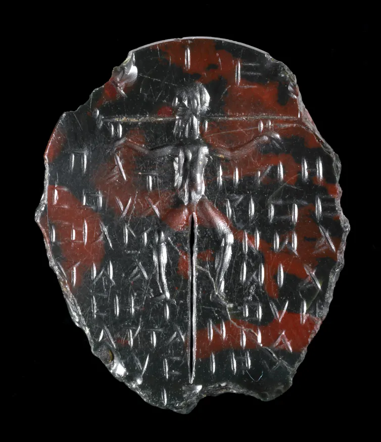 Green-brown jasper; oval with a crucified figure on a tall cross with a short base.
