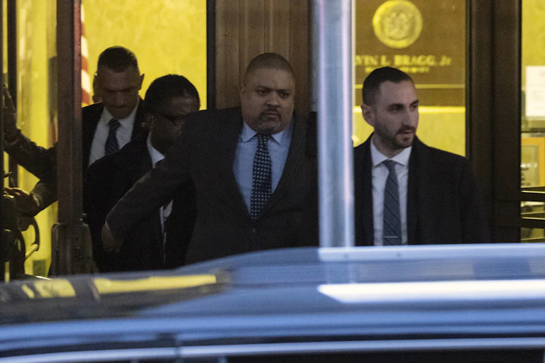 Four men inside a building, leaving it.