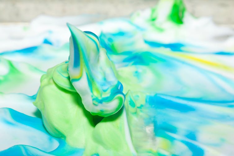 Green and blue dye mixed into shaving cream.
