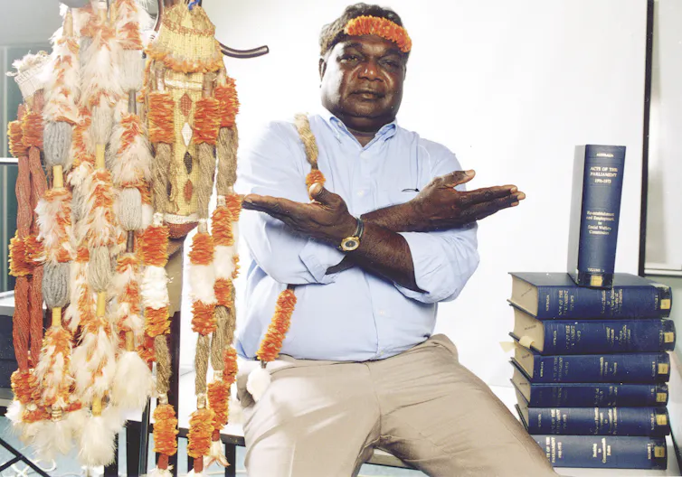 Yunupiŋu with traditional art and law books.