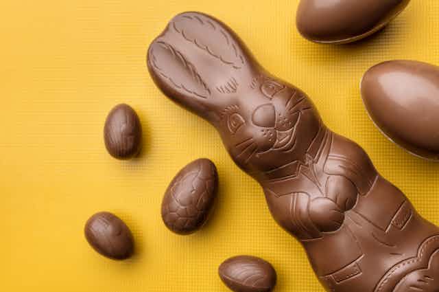 chocolate bunny and eggs on yellow background