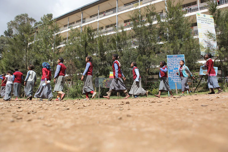 Girls in school uniform waling in a line