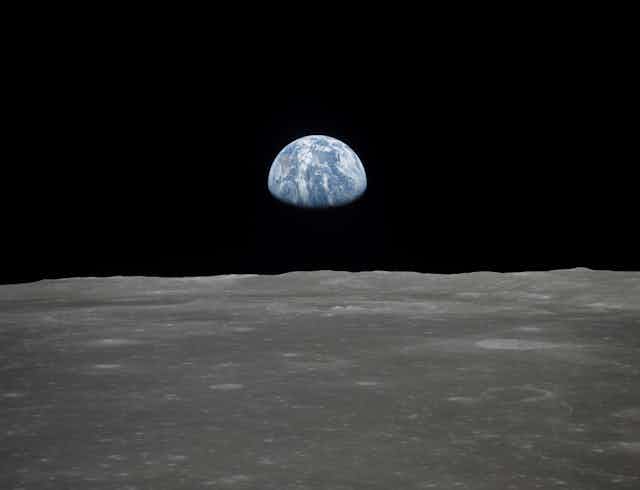 Earth rising over the horizon of the Moon.