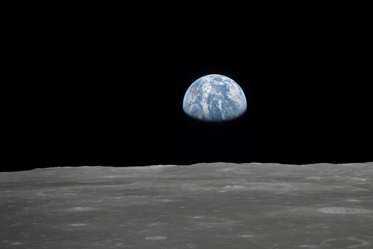 Earth rising over the horizon of the Moon.