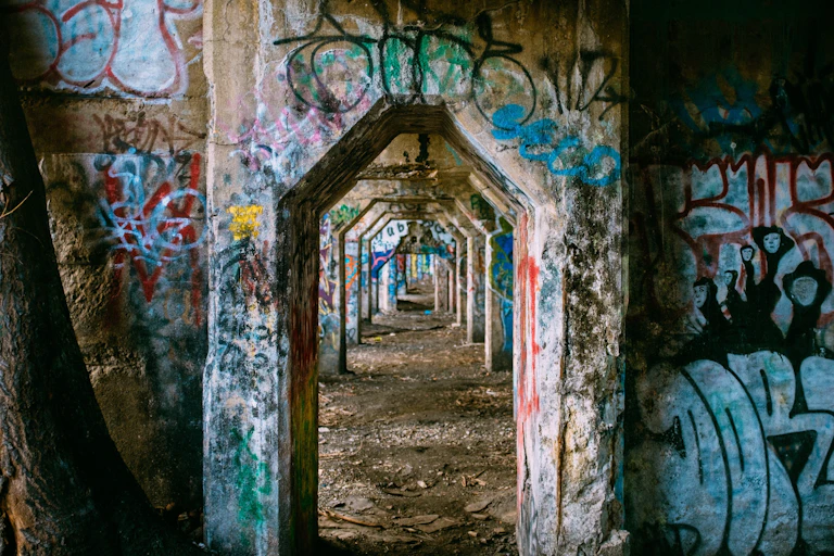 A series of concrete structures covered with graffiti.