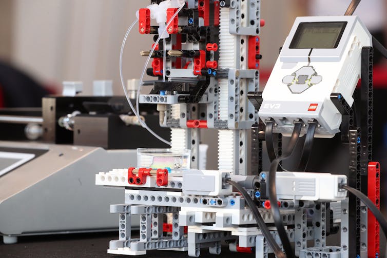 A machine made of Legos of different sizes and colors.