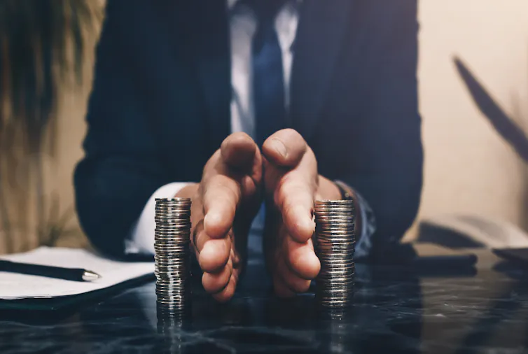 Businessman separates stacked coins