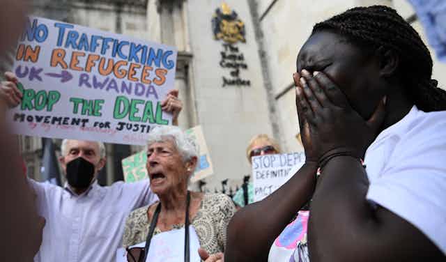 Woman crying during protest outside High Court in London