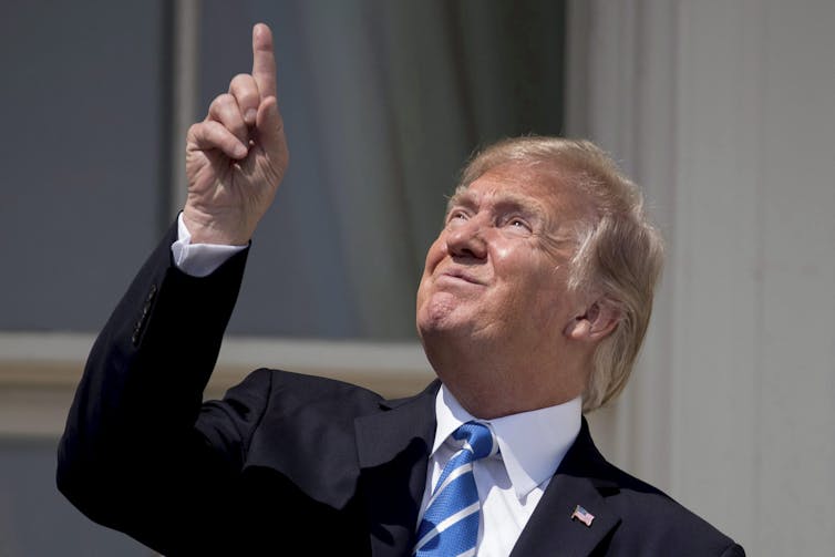 Trump points at the sun