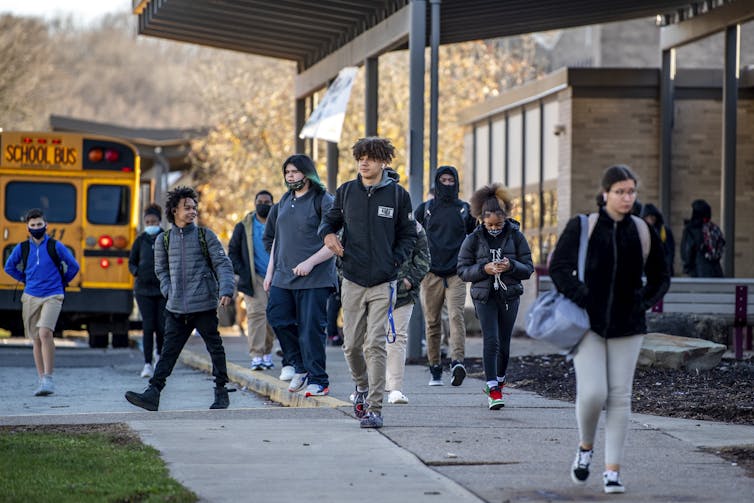 Students seen walking in front of a school.