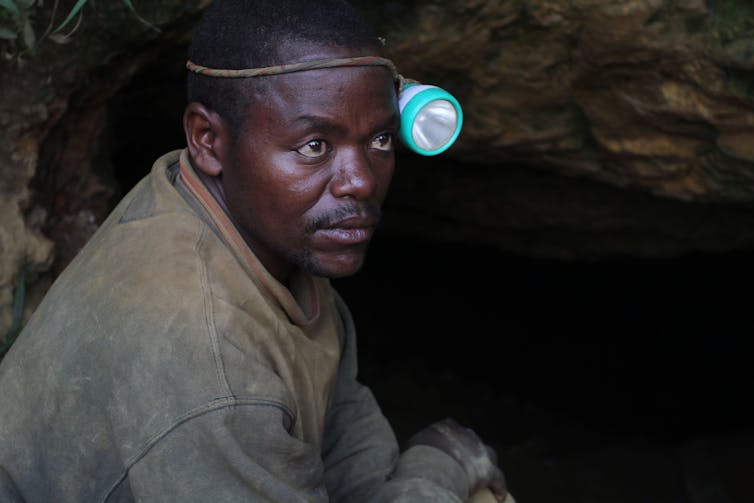 A man seen wearing a mining light.