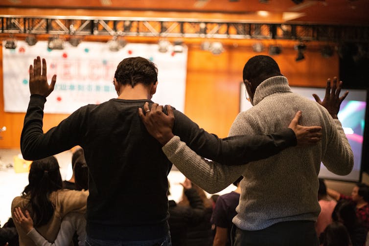 Two men pray at church