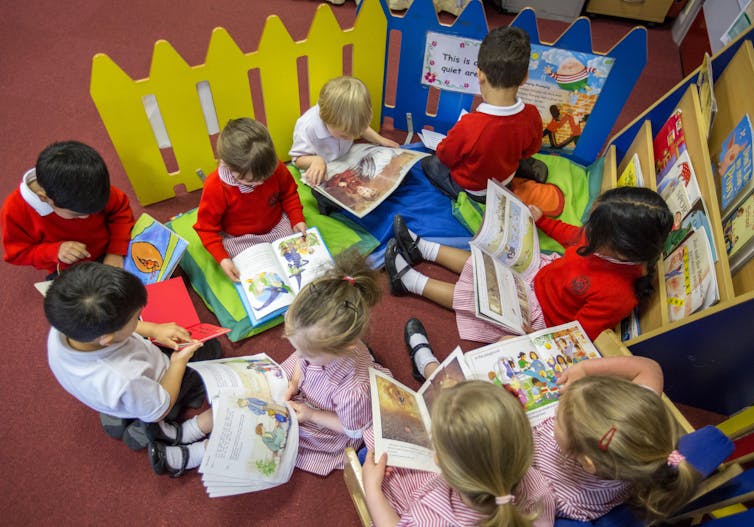 Children reading in a group at school.