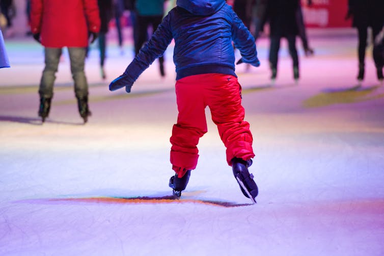 People skating in an ice rink.