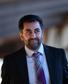 Scotland's new first minister Humza Yousaf dressed ina suit and a tartan tie.