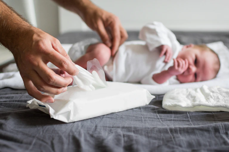 Baby with wet wipes.