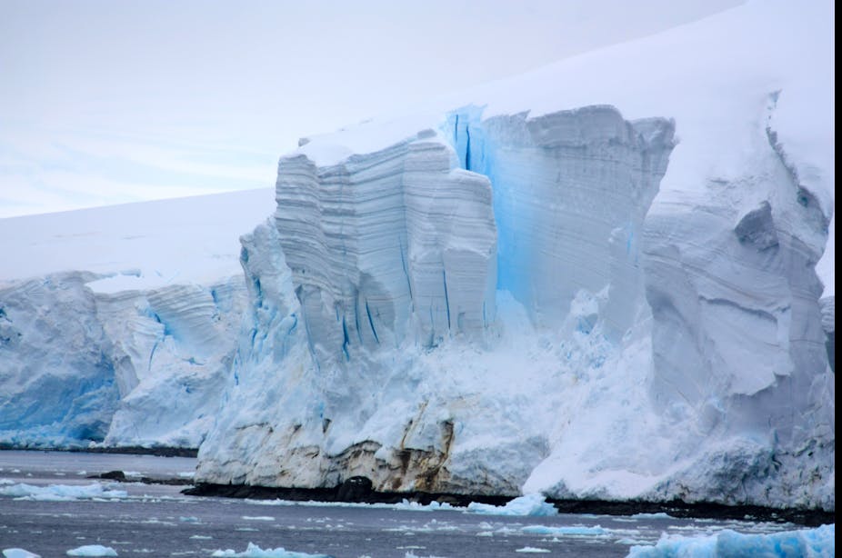 A glacier collapsing into the sea.