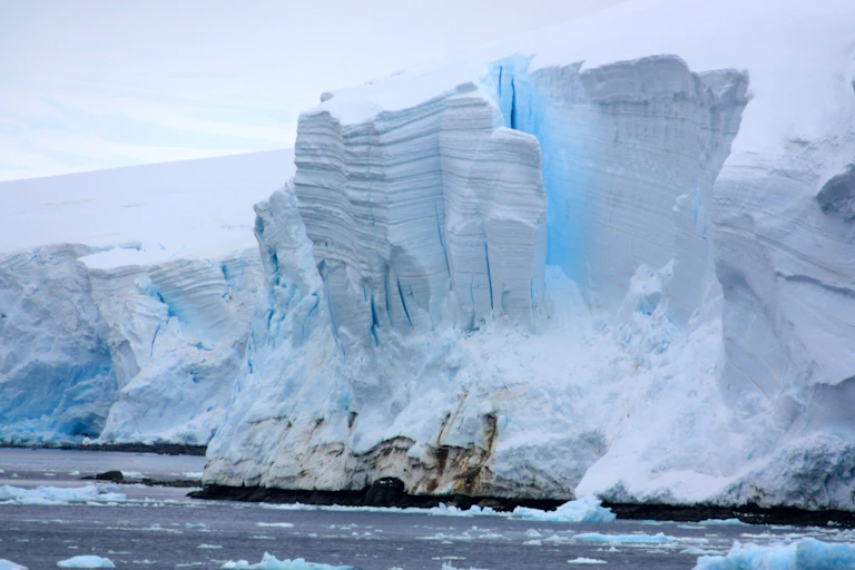 A glacier collapsing into the sea.