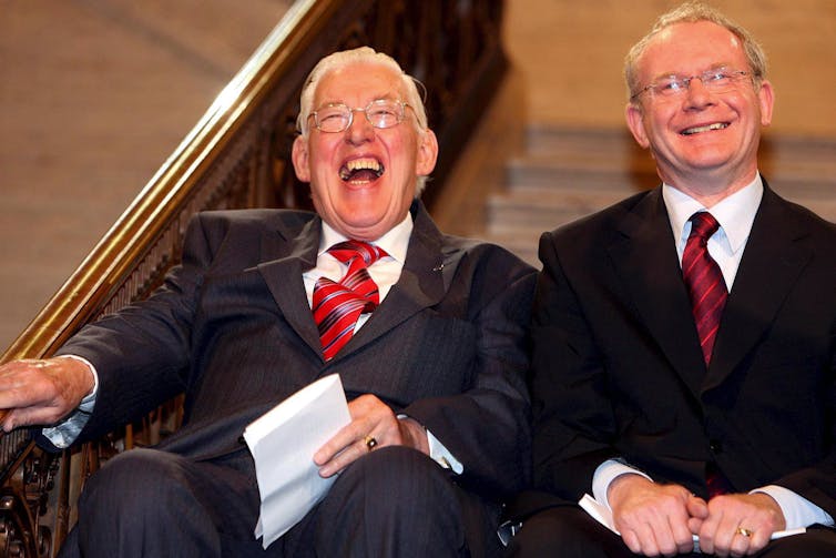 Rev Ian Paisley and Martin McGuinness laughing together.