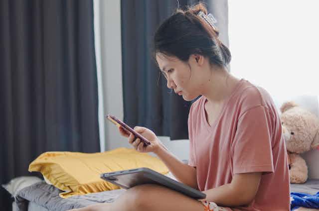 Girl using tablet and mobile phone