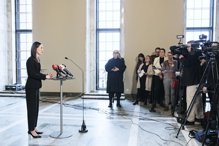 Sanna Marin standing at a lectern in front of the media