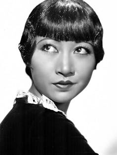 A woman seen with a bob haircut in black and white photo.