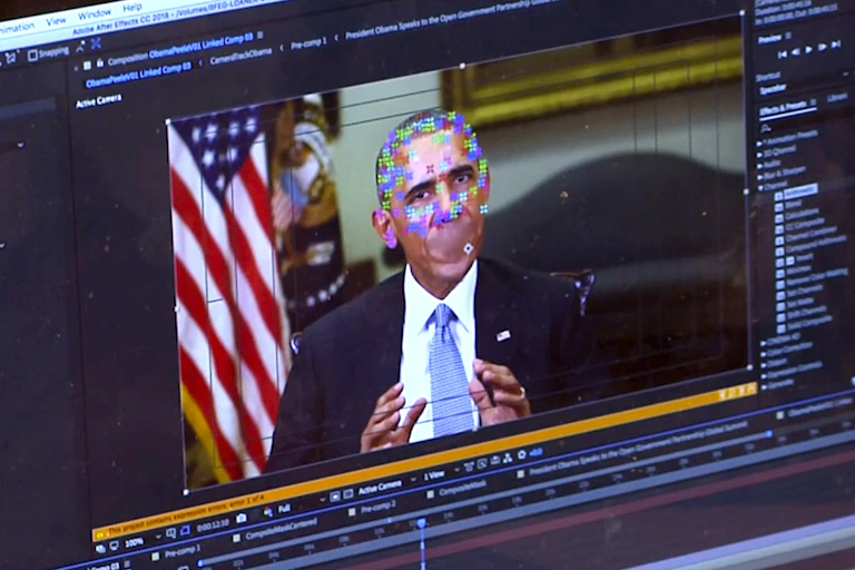a screen showing a video player with an image of former president barack obama. layered on top of his face are multicoloured pixels