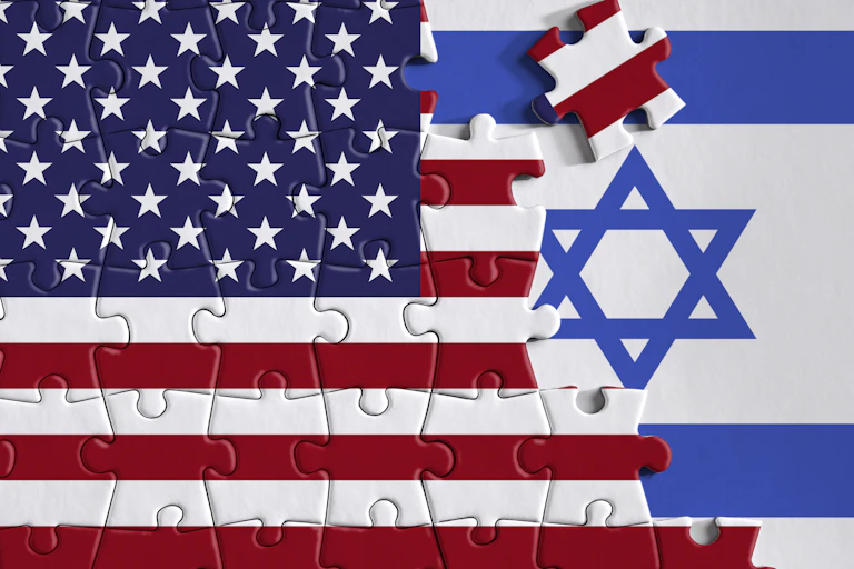 A puzzle piece of the United States flag is placed over a blue and white stripped flag with a Jewish star.