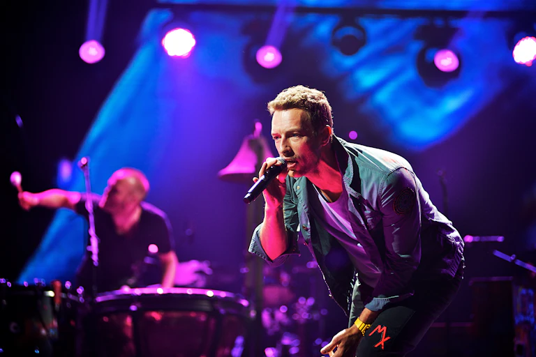 Chris Martin singing on stage.