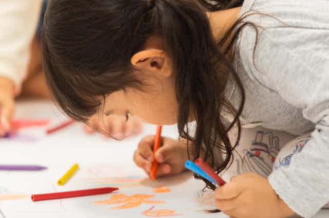 Young girl concentrating on drawing